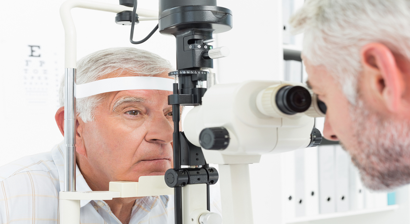 Doctor performs eye exam on a senior